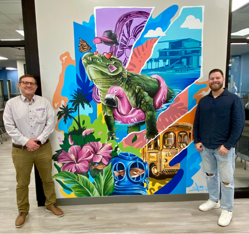 Tax Collector Adam Ross and Frankie G in front of gator mural